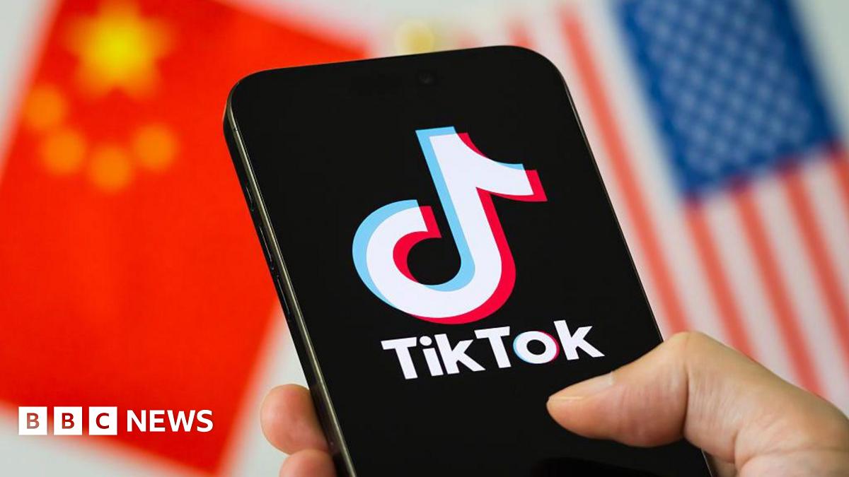 A smartphone screen displays the TikTok logo against a backdrop of the Chinese and US flags.