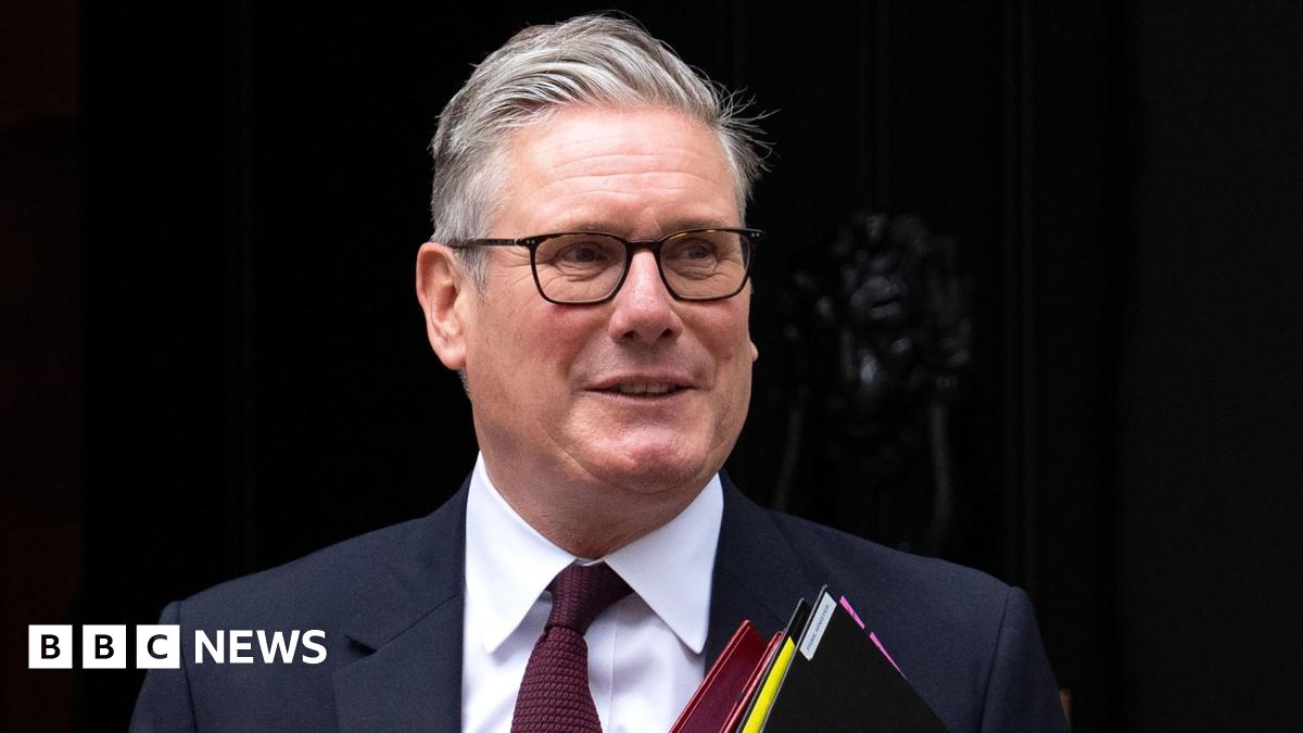 A resident walks with a shovel along a mud-covered road in Hualien on September 24, 2025, following the bursting of a barrier lake during the passing of Super Typhoon Ragasa.