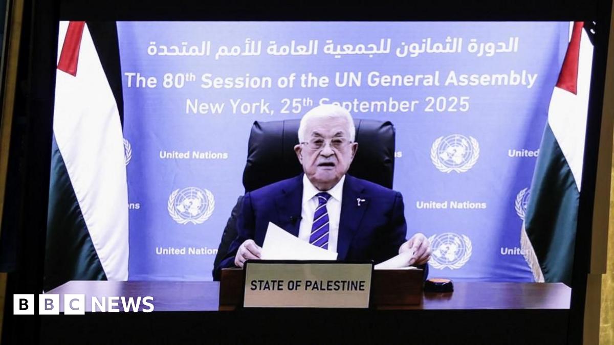 A resident walks with a shovel along a mud-covered road in Hualien on September 24, 2025, following the bursting of a barrier lake during the passing of Super Typhoon Ragasa.
