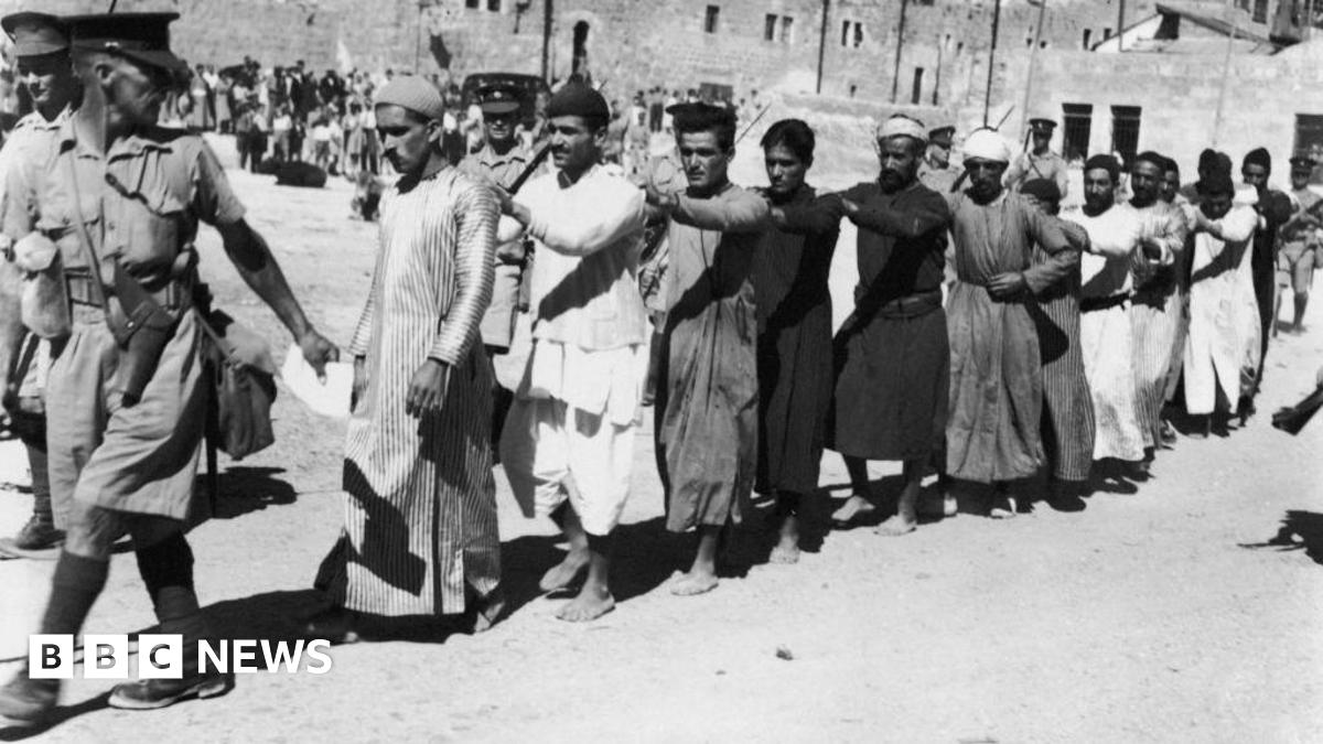 British soldiers escort a group of Arab prisoners from Jerusalem after a revolt against the British Mandate in Palestine. Photo: 26 October 1938