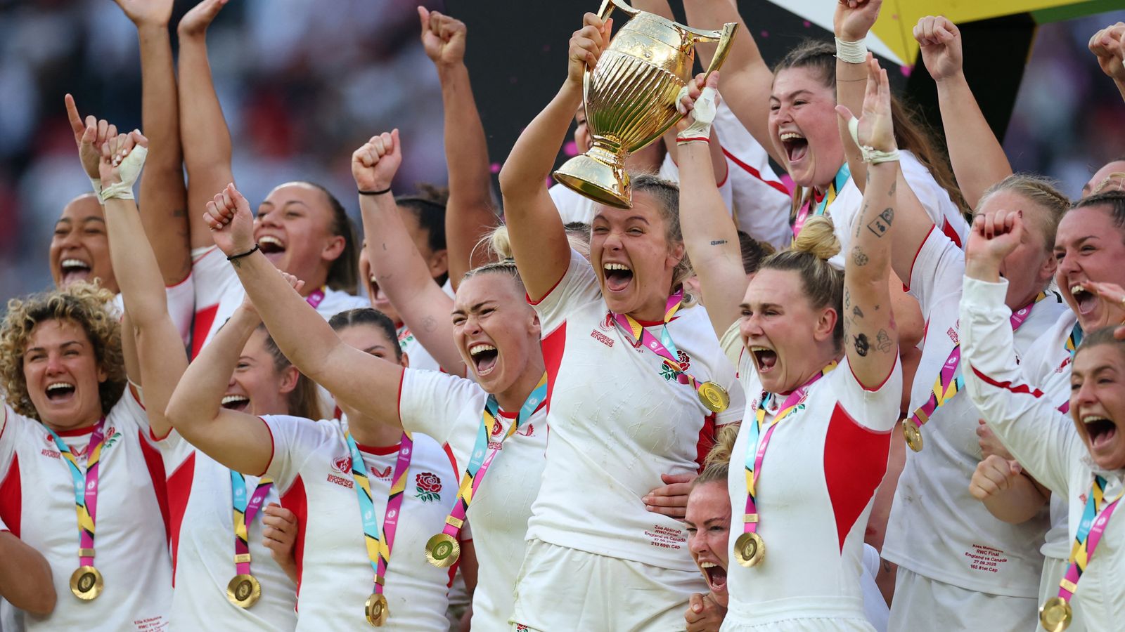 England's Zoe Aldcroft and Megan Jones lift the trophy. Pic: Reuters