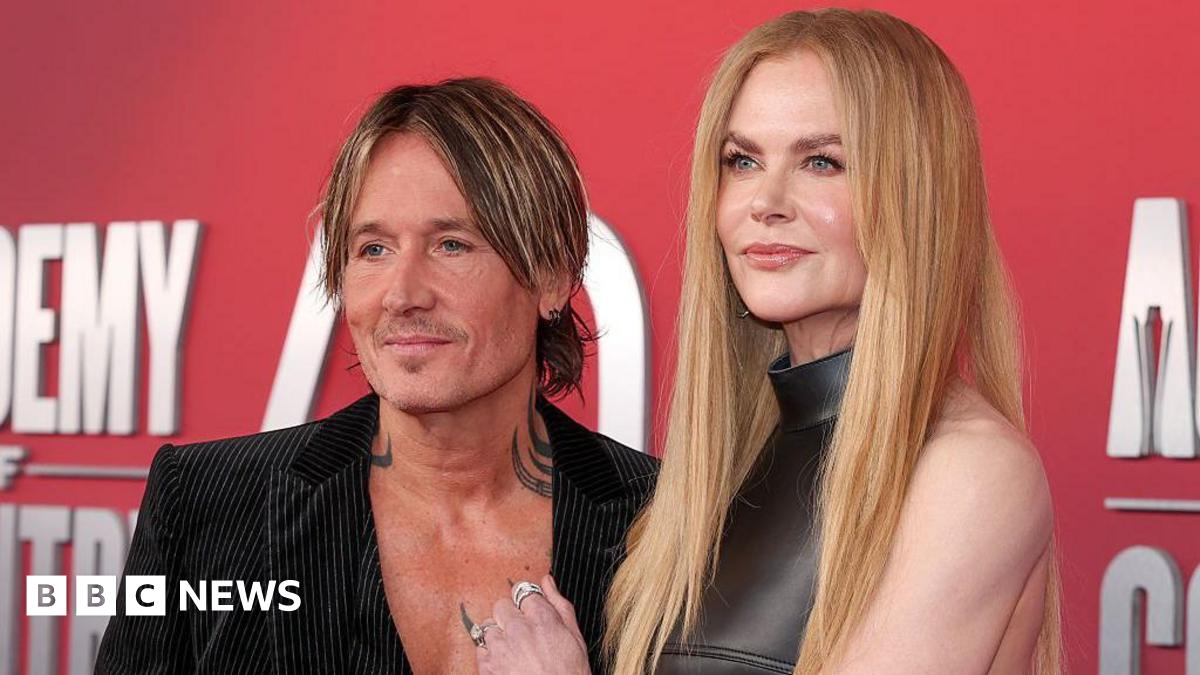 Keith Urban and Nicole Kidman appear on a red carpet for a country music honours award show in May.