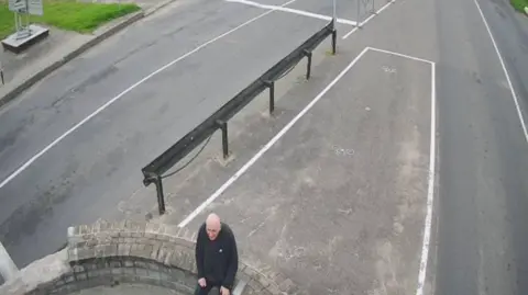 @Tsihanouskaya/X A man sits on a wall at the border 