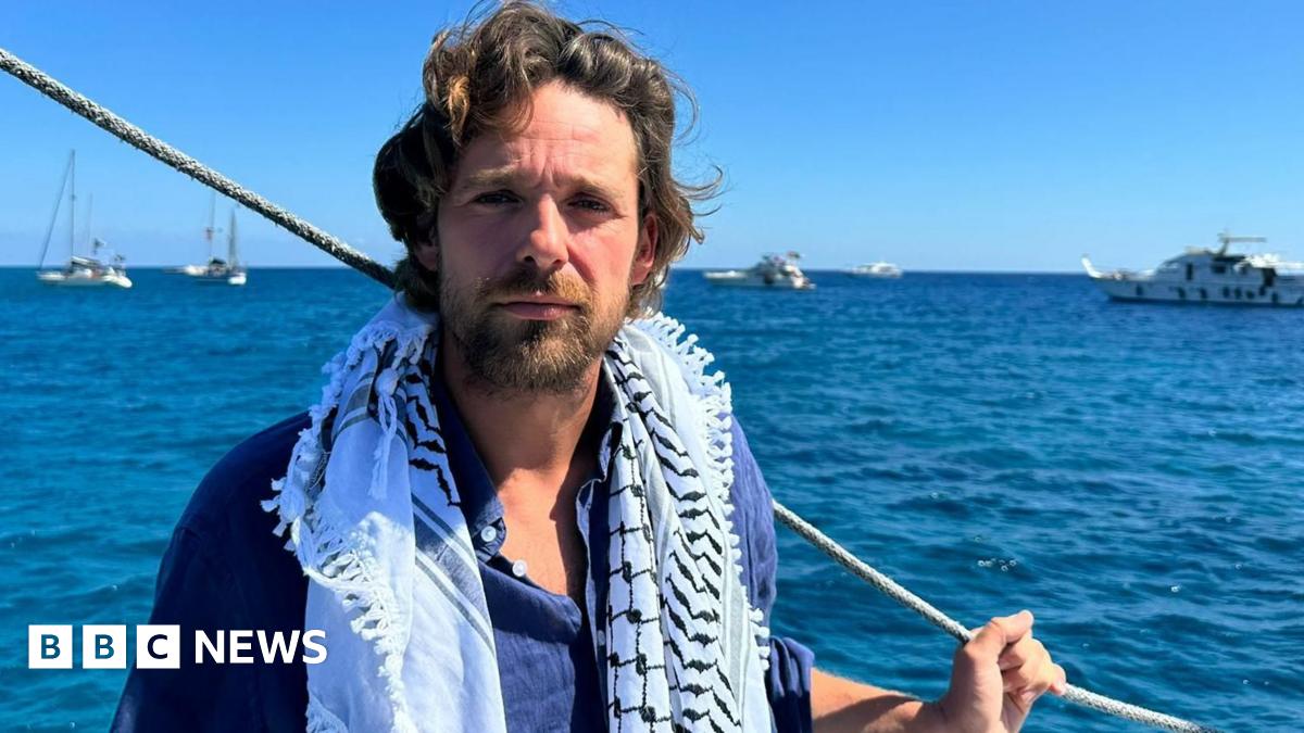 Palestinians react as they wait to receive food from a charity kitchen