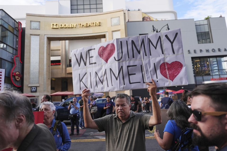 A demonstrator holds a sign outside El Capitan Entertainment Centre, where the late-night show Jimmy Kimmel Live! is staged (Jae C. Hong/AP)