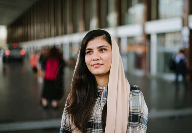 Maryam faces the camera, smiling.