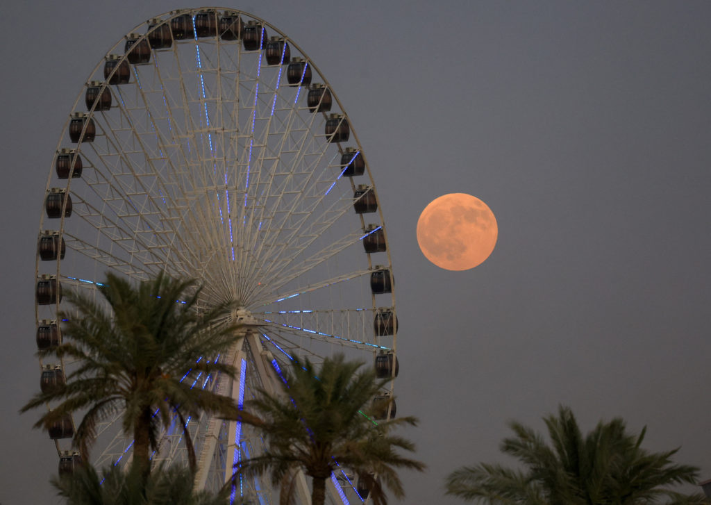 The "Blood Moon" rises in the sky during a total lunar eclipse,in Baghdad