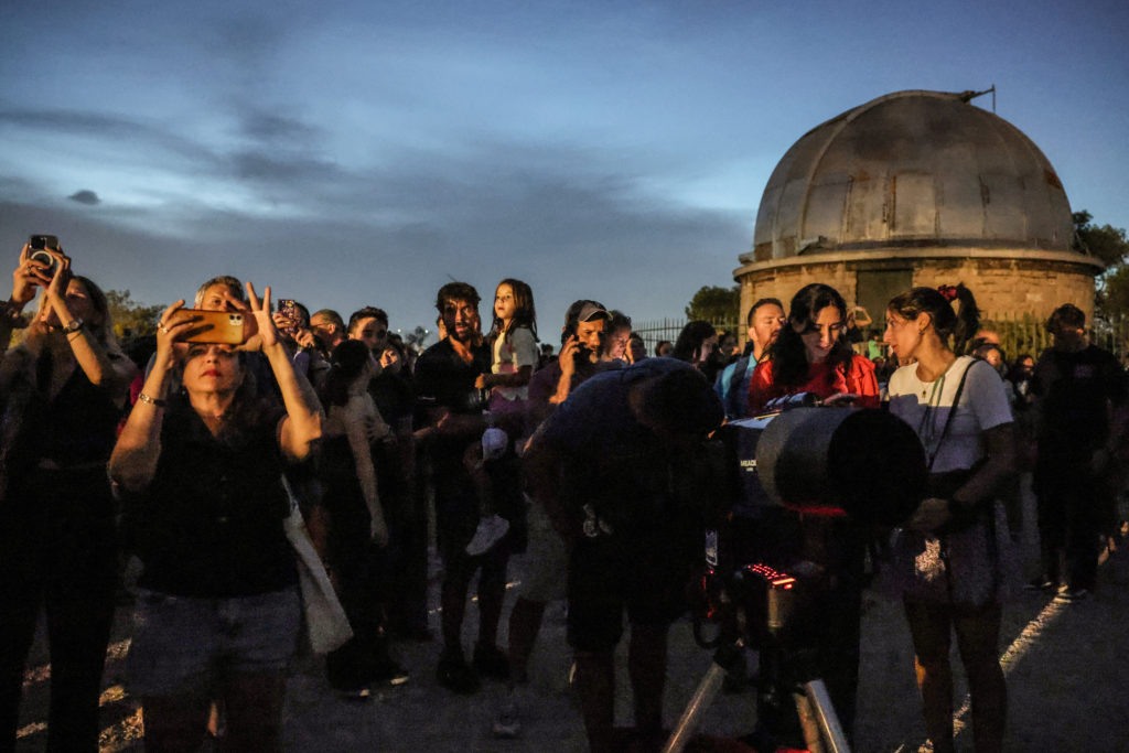 People watch total lunar eclipse in Athens