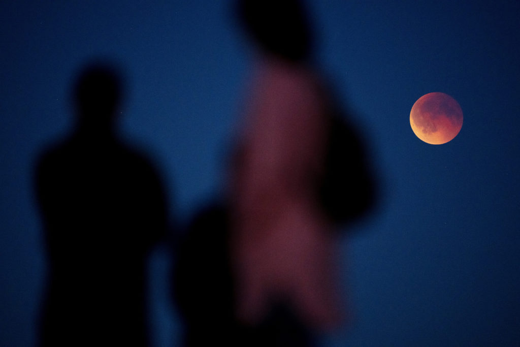 People watch blood moon during total lunar eclipse in Koege