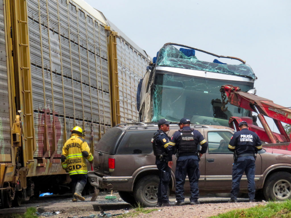 Authorities work at the scene where a passenger bus was struck by a train, in Atlacomulco