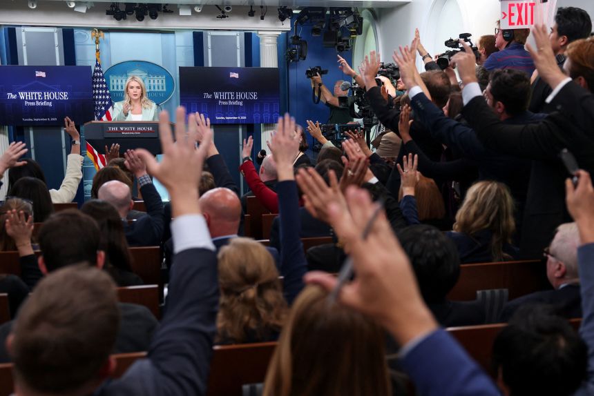 Journalists raise their hands to ask questions, as White House press secretary Karoline Leavitt speaks during a press briefing at the White House in Washington, DC, US, September 9, 2025.