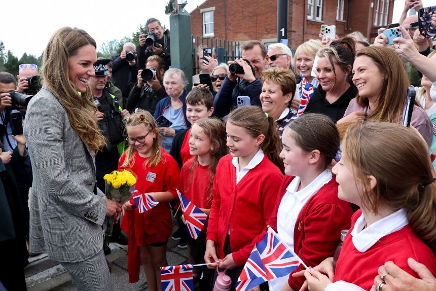 Catherine Princess of Wales greets children in Sudbury, Suffolk, Britain, on September 11, during a tour of British textile manufacturers.