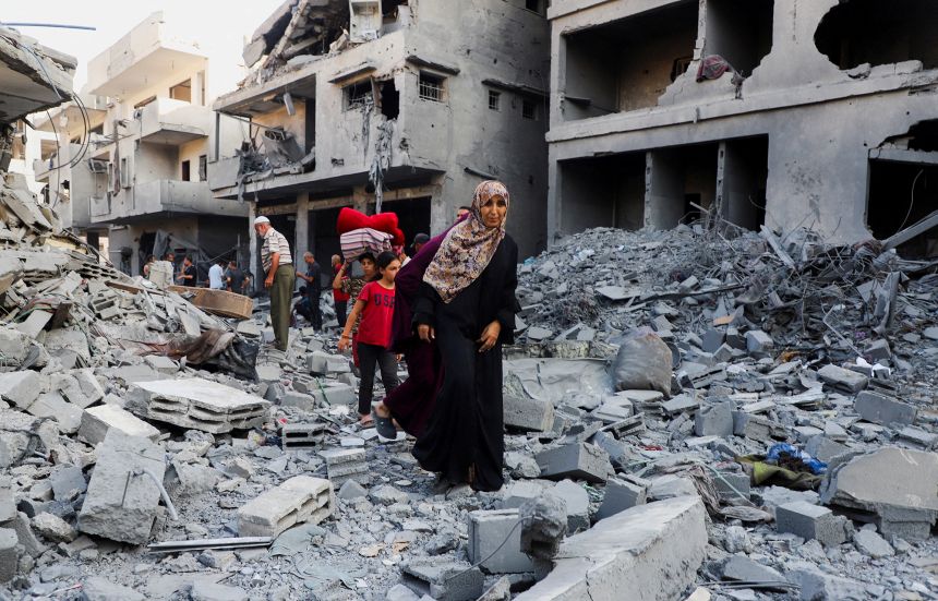 Palestinians inspect the site of an overnight Israeli strike on a house in Gaza City, September 16, 2025.