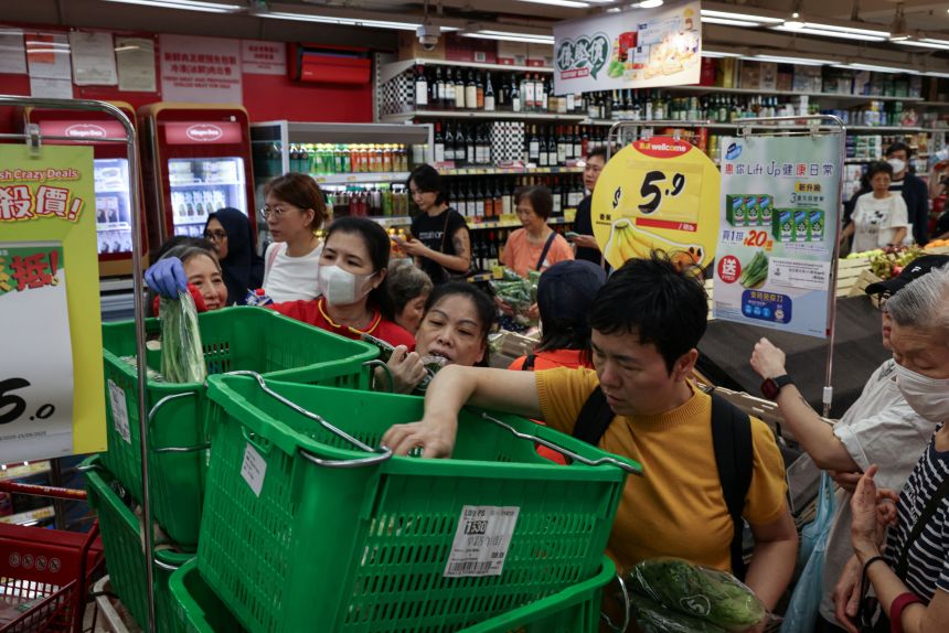 Residents in Hong Kong stock up on supplies at a supermarket on Monday. Officials in the region announced a spate of emergency measures including school closures and transport suspensions.
