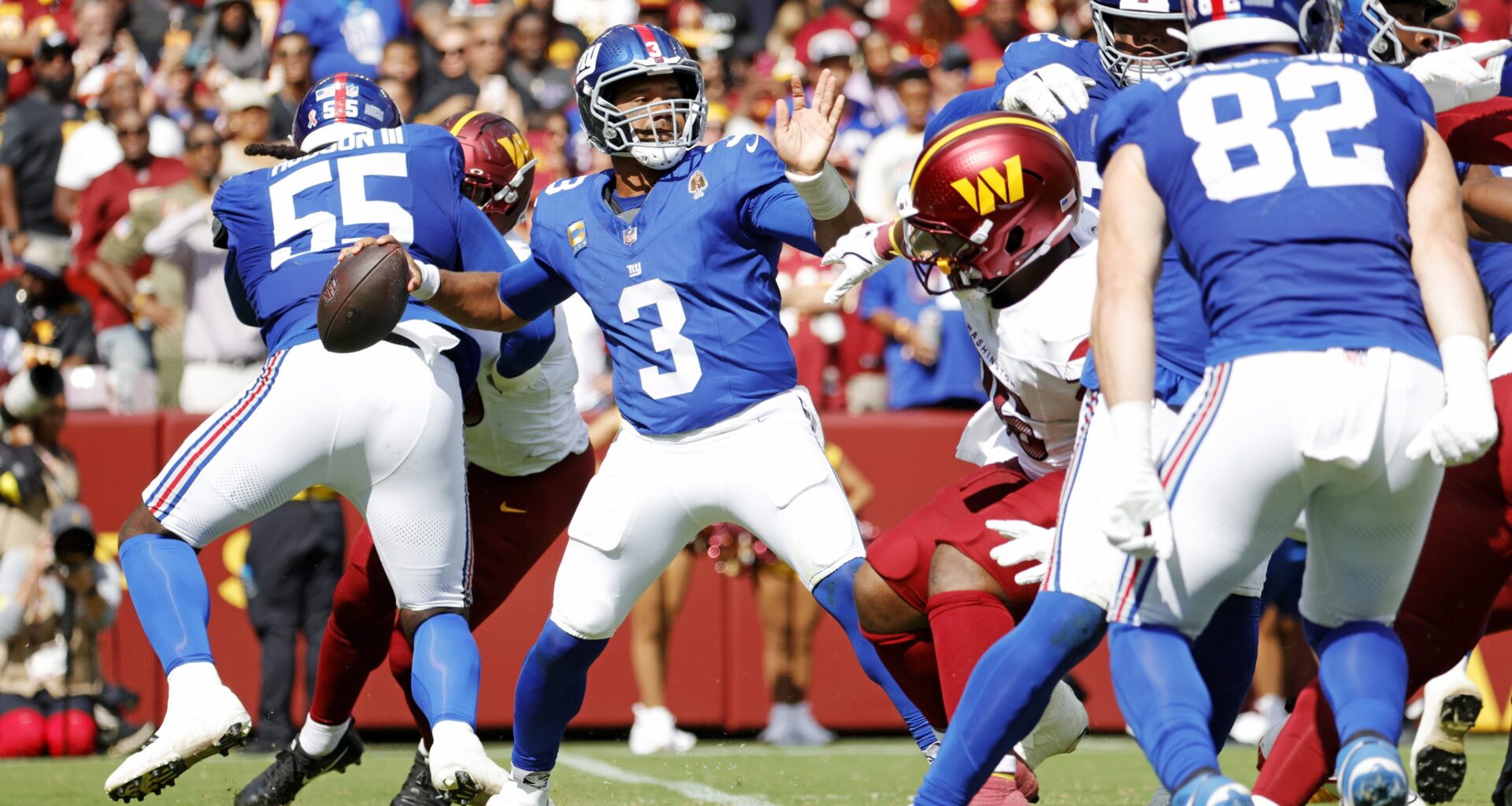 Russell Wilson steps back in the pocket and attempts a pass.