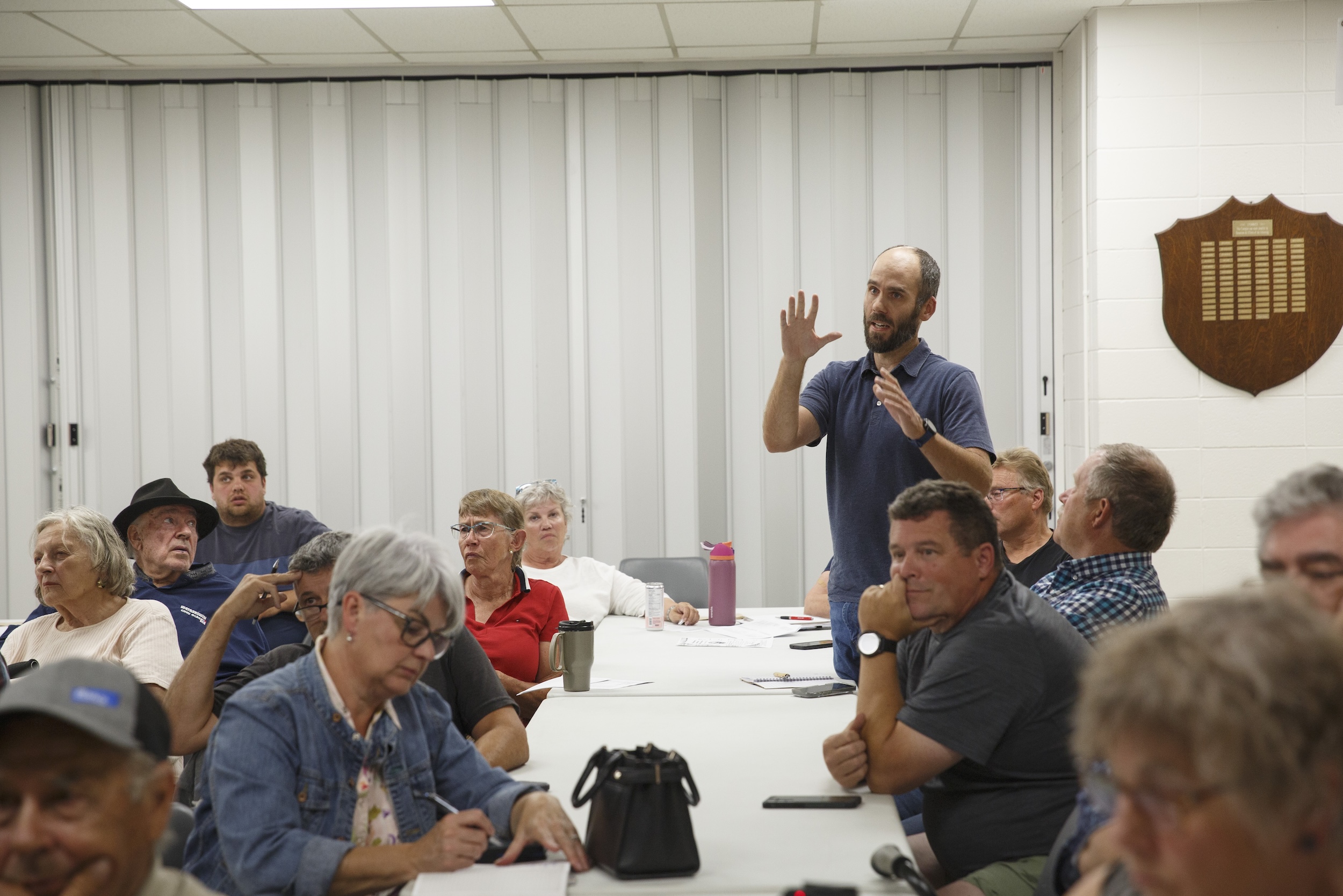 A man standing and speaking at a surface rights meeting in Warburg, Alta