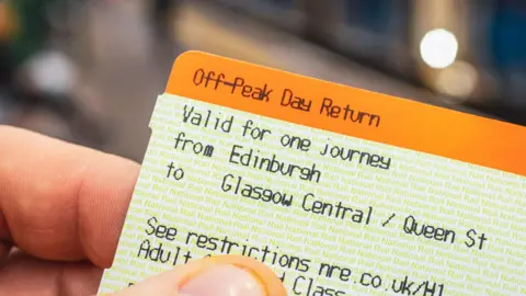 Getty Images A close up image of a train ticket from Edinburgh to Glasgow Central, held in someone's hand. The ticket is orange and white.