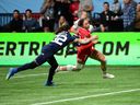 Canada's Florence Symonds (right) scores a try during the HSBC World Rugby Sevens Series women's rugby match between Canada and USA at B.C. Place Stadium on Feb, 23, 2025. 