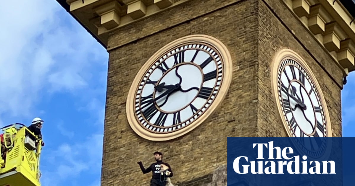 Man with dog unfurls Iran protest banner from King’s Cross clock tower | London