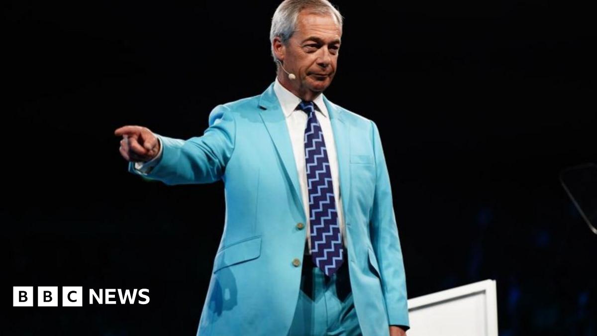 Reform UK leader Nigel Farage points off stage as he addresses the party's conference at the National Exhibition Centre in Birmingham