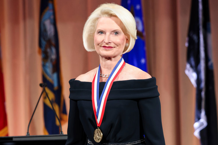 Callista Gingrich smiles and wears a medal