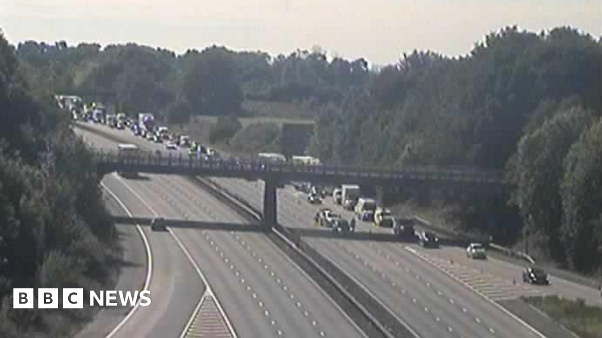 Long queue of vehicles on the M1 motorway on one side with the other empty.