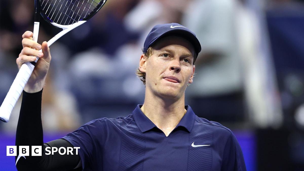 Jannik Sinner raises his racquet to the US Open crowd