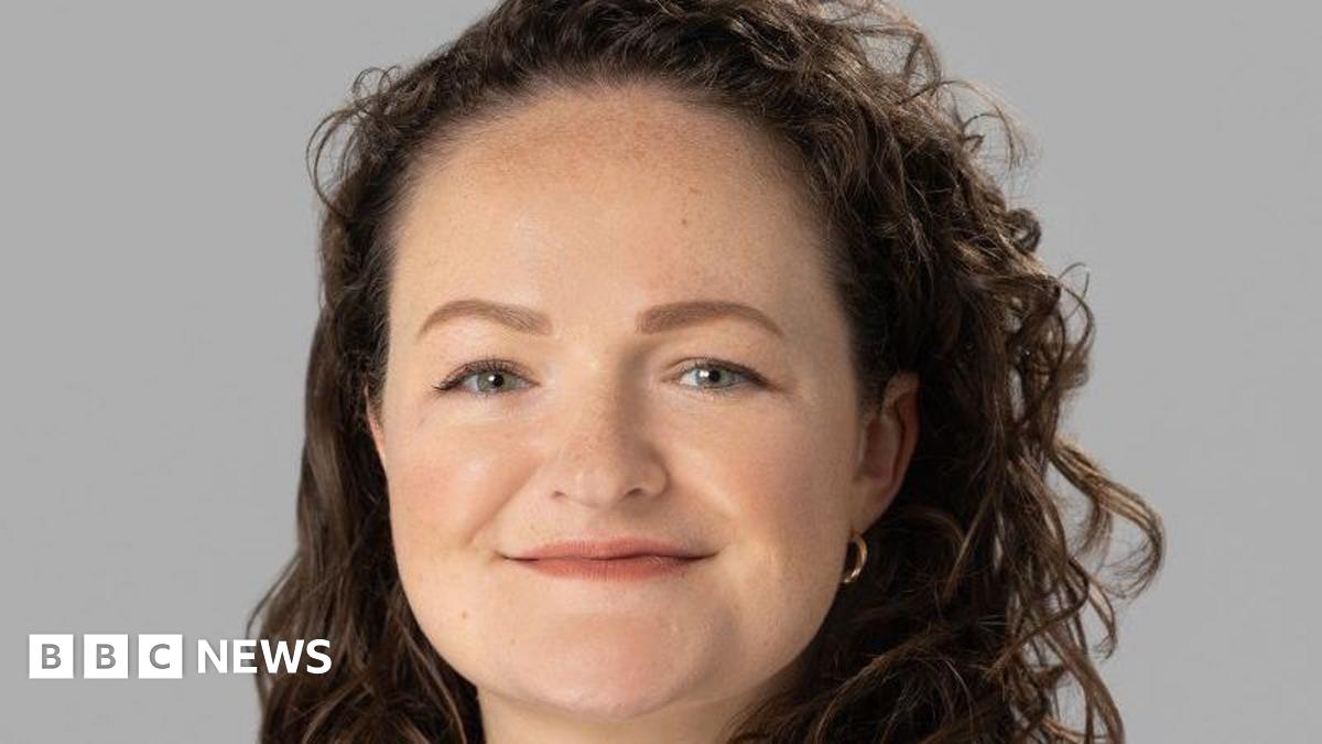 A resident walks with a shovel along a mud-covered road in Hualien on September 24, 2025, following the bursting of a barrier lake during the passing of Super Typhoon Ragasa.