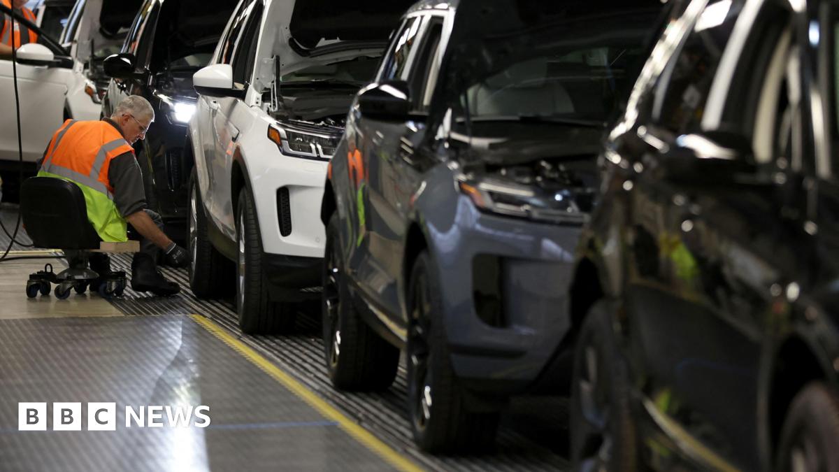 A staff member assembles Range Rover Evoque SUVs on the production line at Jaguar Land Rover's Halewood factory in Liverpool