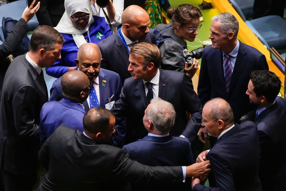 French President Emmanuel Macron, center, arrives inside the General Assembly Hall for a high-profile meeting at the United Nations aimed at galvanizing support for a two-state solution to the Israeli-Palestinian conflict Monday, Sept. 22, 2025, at UN headquarters. (AP Photo/Yuki Iwamura)