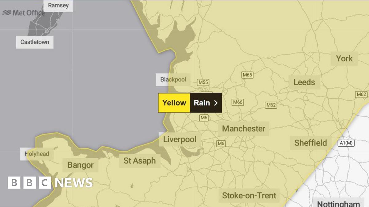 A Met Office weather map shows a yellow band across the north-west of England and into North Wales.