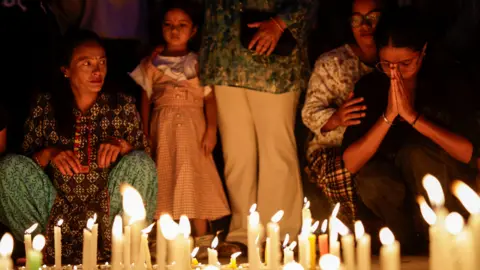 Reuters People take part in a candlelight vigil in memory of people who died during the protest against anti-corruption triggered by a social media ban 