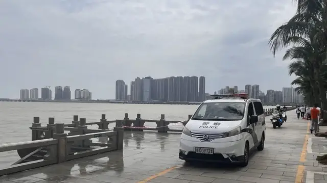 Police cars are standing by near the water