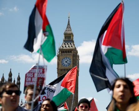 National march for Palestine in London Big Ben in the background and people holding flags