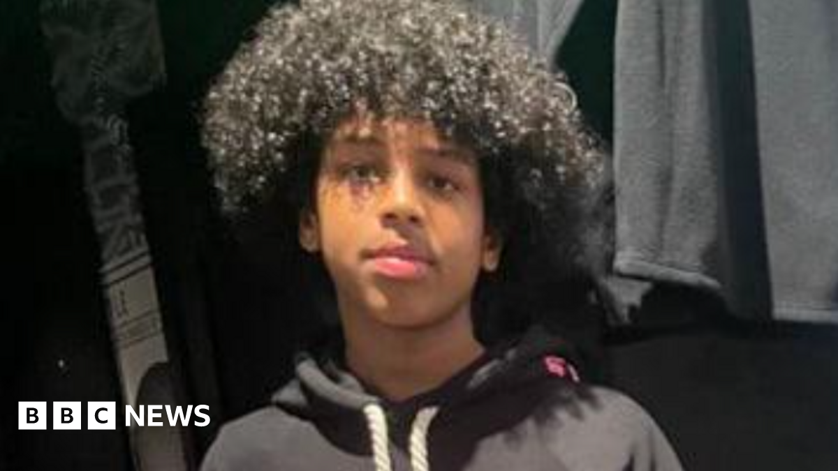 Mohanad Abdullaahi Goobe. He had short curly hair and is wearing a dark hoodie.