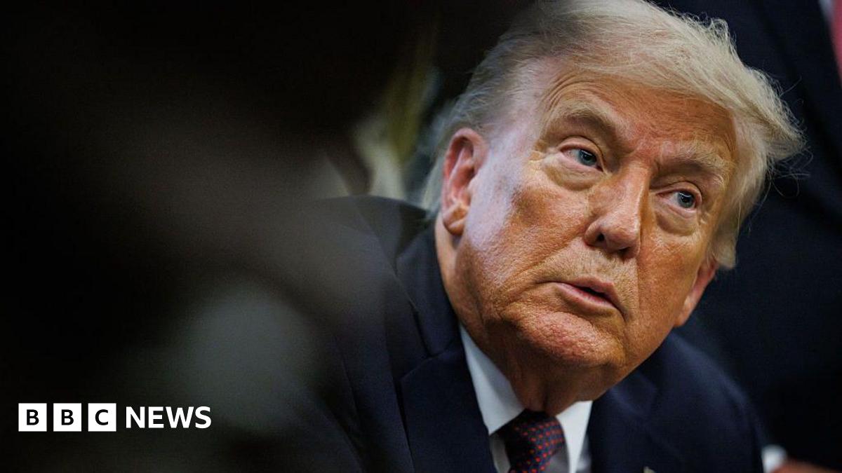 Donald Trump wearing a dark suit and tie