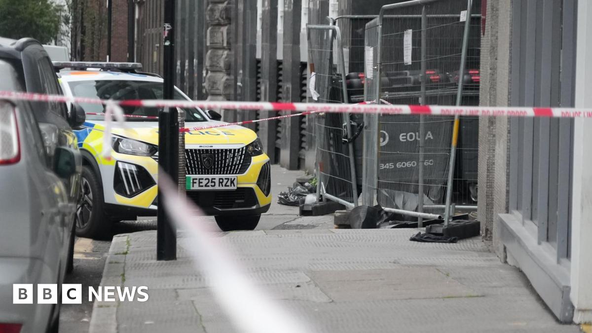 A police car outside at the Thistle City Barbican Hotel. The area is surrounded by police tape