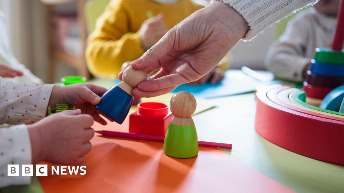 A resident walks with a shovel along a mud-covered road in Hualien on September 24, 2025, following the bursting of a barrier lake during the passing of Super Typhoon Ragasa.