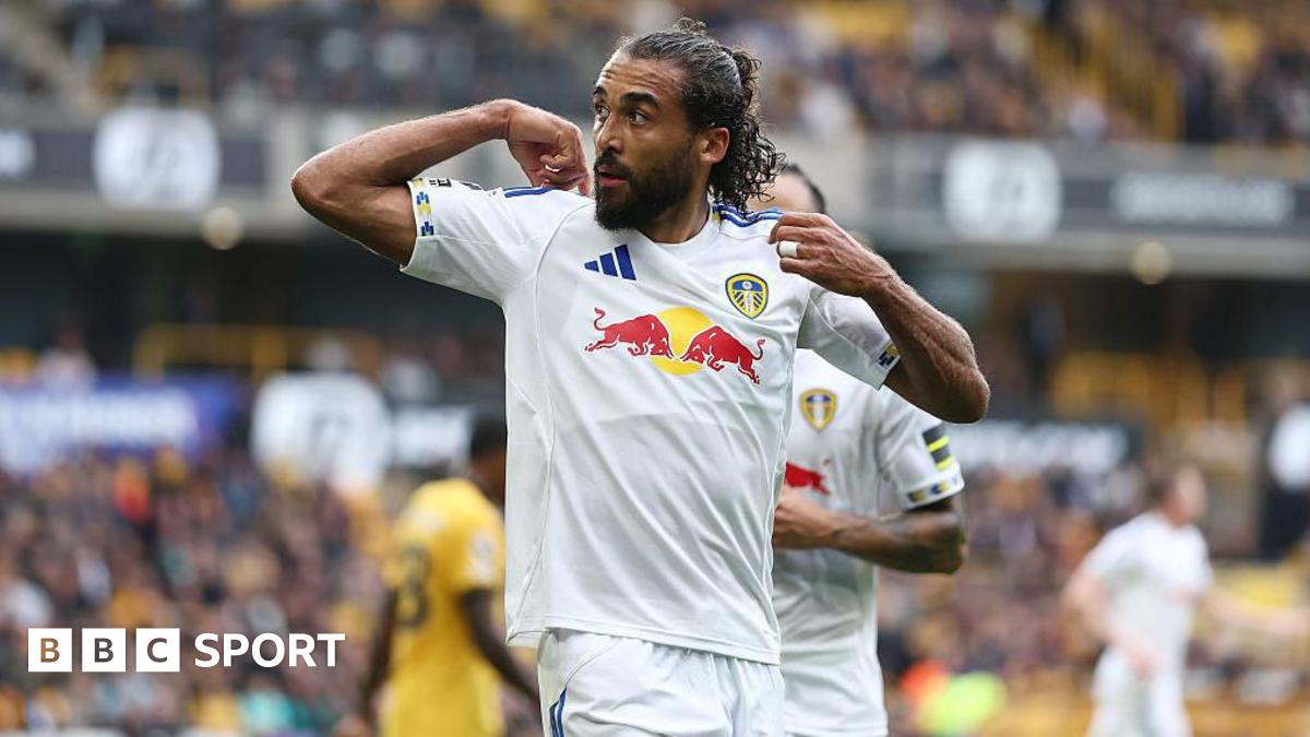 Dominic Calvert-Lewin points to the back of his shirt after drawing Leeds level against Wolves
