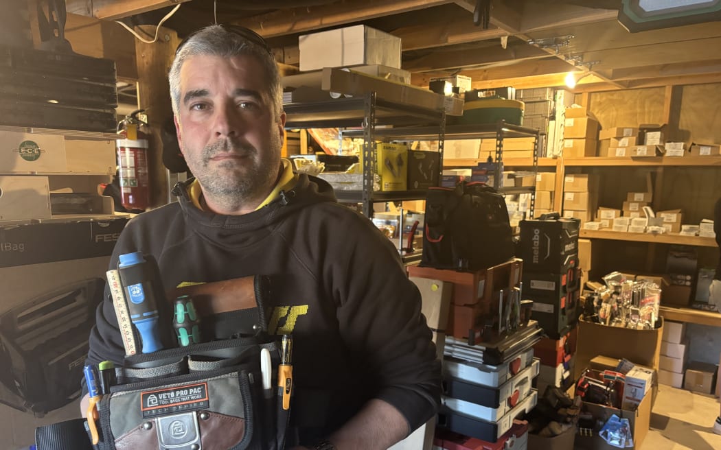 Gaston Monge-Grassi with the tool belt stolen from his work ute that he won back after discovering it was being sold at auction.