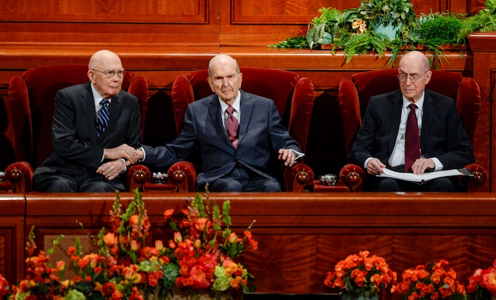 (Leah Hogsten | The Salt Lake Tribune) President Russell M. Nelson reaches out to squeeze the hand of Dallin H. Oaks during General Conference in 2019.