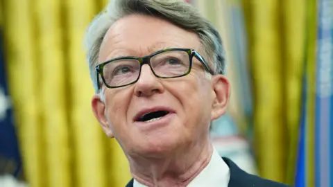 EPA Lord Mandelson appearing with a close up show. He is wearing dark framed glasses and his mouth is slightly open 