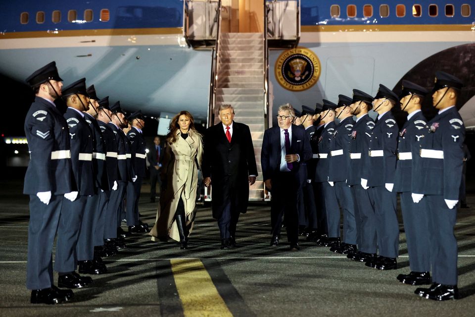U.S. President Donald Trump and first lady Melania Trump are welcomed by Viscount Henry Hood upon arrival at London Stansted Airport for a state visit to Britain, near London, Britain, September 16, 2025. REUTERS/Kevin Lamarque