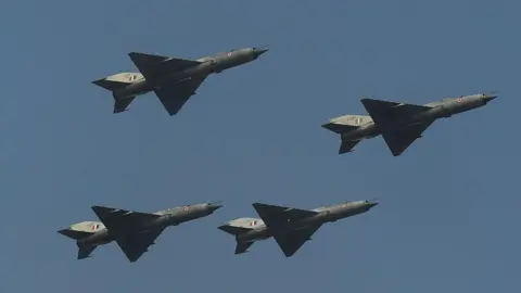 AFP via Getty Images Indian Air Force of MIG 21FL fighter aircraft are seen in a 'Box' formation for the final time during a fly-past at the last ceremonial flight of the MIG 21 at a phasing out ceremony at Air Force Station Kalikunda (WB) near Kharagpur, some 110kms west of Kolkata on December 11, 2013. Three MiG-27 aircraft performed the Trishul Break Manoeuvre as a salute to the MiG-21 type 77 aircraft, which were first inducted in March-April 1963 and heralded the arrival of the Indian Air Force in the Supersonic era. AFP PHOTO/Dibyangshu SARKAR (Photo credit should read DIBYANGSHU SARKAR/AFP via Getty Images)