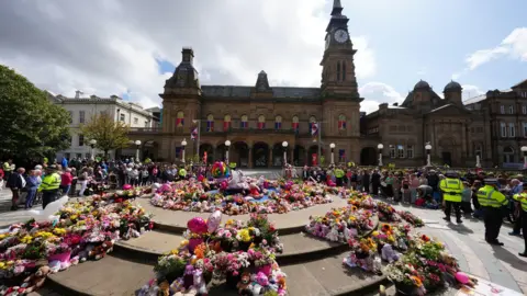 PA Media Flowers laid for victims outside Southport Town Hall in the aftermath of the knife attacks