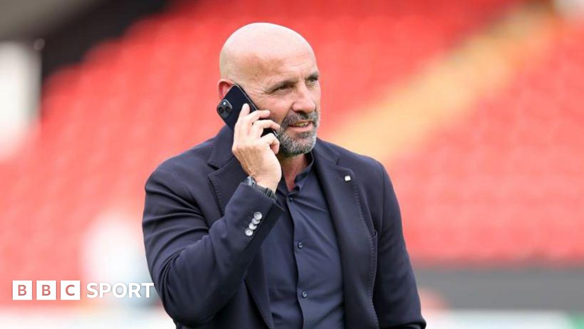 Monchi talks on a mobile phone