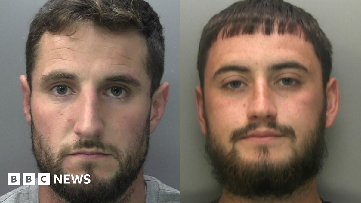 A boy runs with a Palestinian flag atop a mound of rubble at a camp