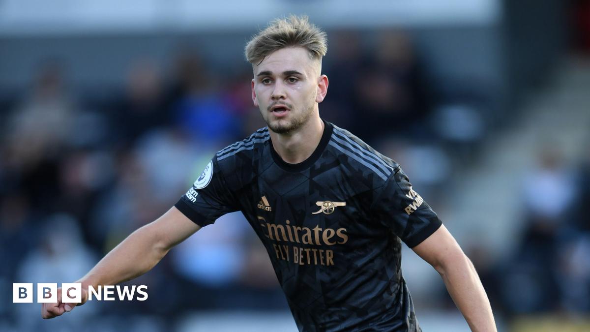 A resident walks with a shovel along a mud-covered road in Hualien on September 24, 2025, following the bursting of a barrier lake during the passing of Super Typhoon Ragasa.