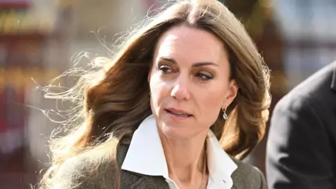 PA Media A shoulder cropped photo of Catherine. She is wearing a tweed-style jacket and white shirt. She has blonde hair. 