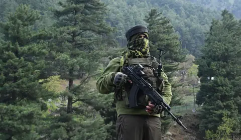 AFP via Getty Images An Indian paramilitary serviceman keeps watch in Pahalgam, south of Srinagar on April 23, 2025, following an attack. 